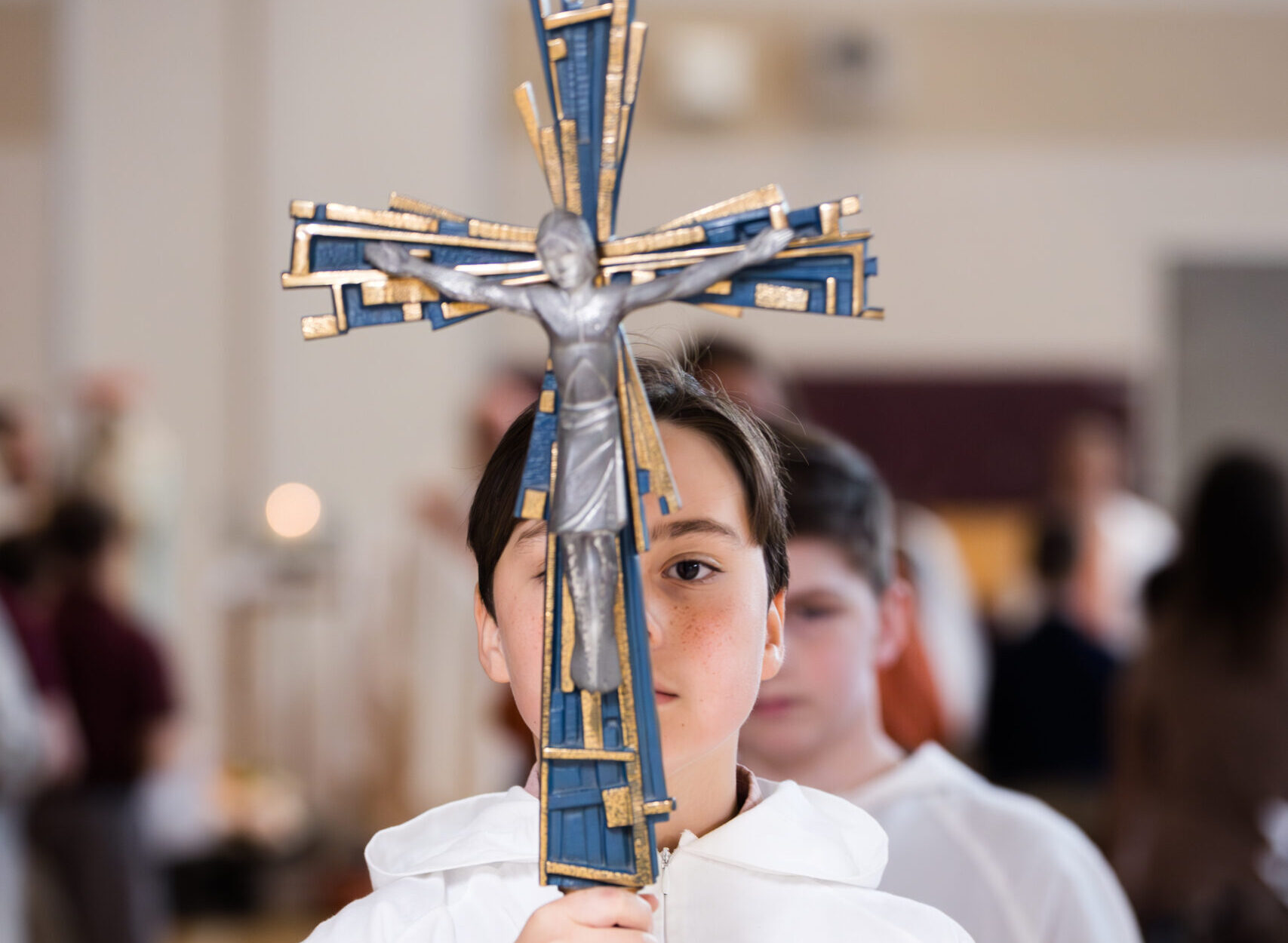 Alter server holding a crucifix